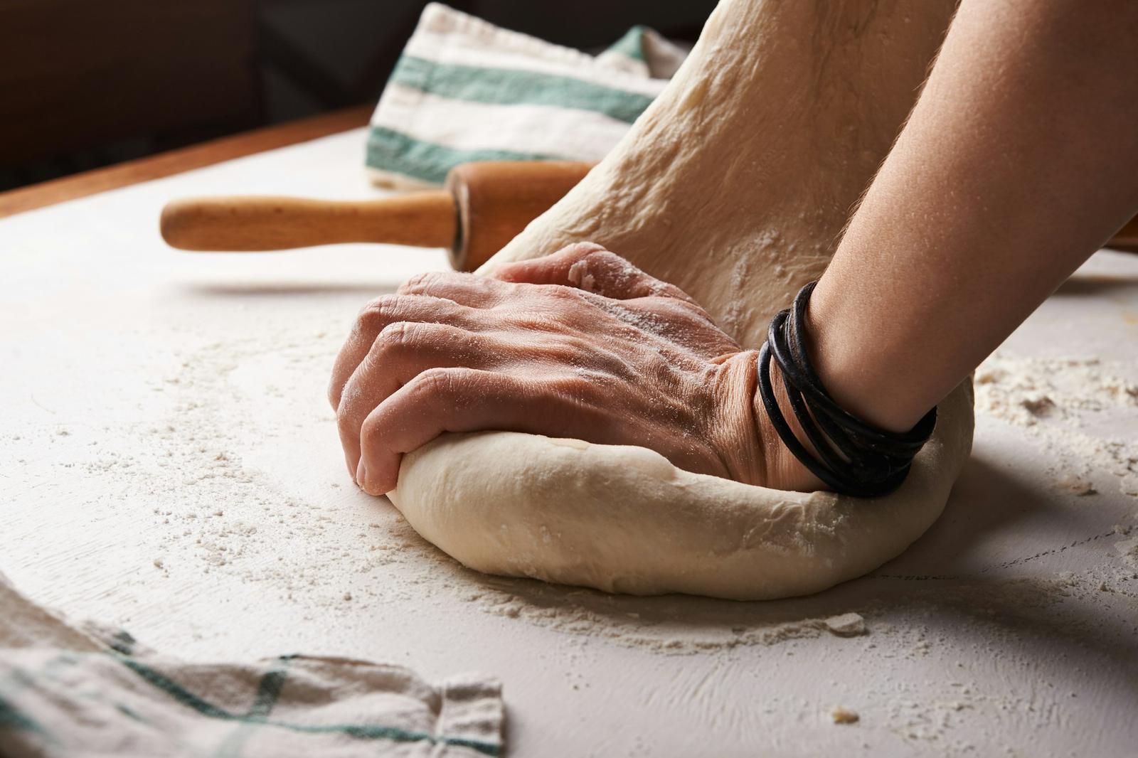 Mains qui pétrissent une pâte